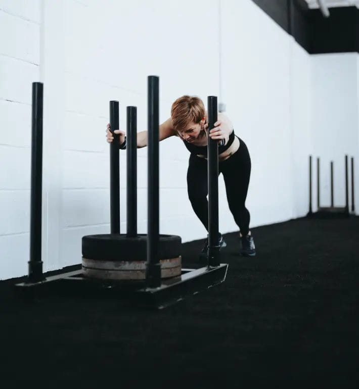 Woman pushing sled